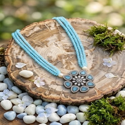 DIVYORO TRIPLE-STRAND BLUE BEAD NECKLACE WITH FLORAL PENDANT