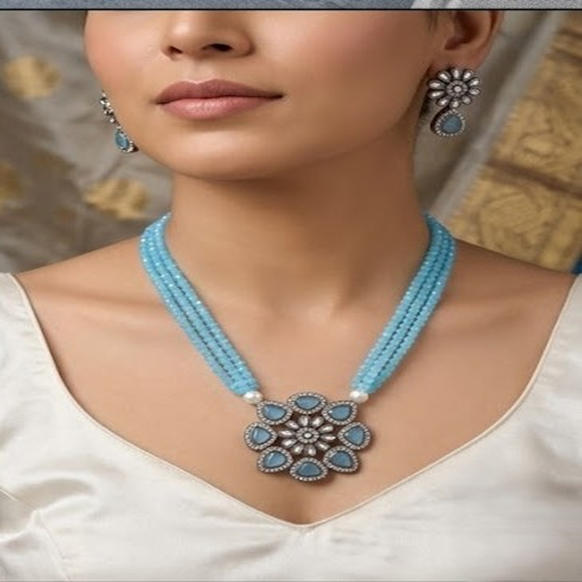 DIVYORO TRIPLE-STRAND BLUE BEAD NECKLACE WITH FLORAL PENDANT