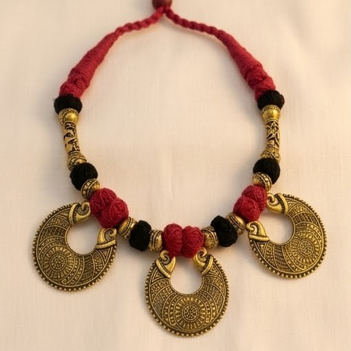 DIVYORO TRADITIONAL RED AND BLACK FABRIC CORD NECKLACE WITH METALLIC DROPS