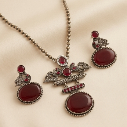 DIVYORO DEEP RUBY GEMSTONE PEACOCK MOTIF OXIDIZED JEWELRY SET
