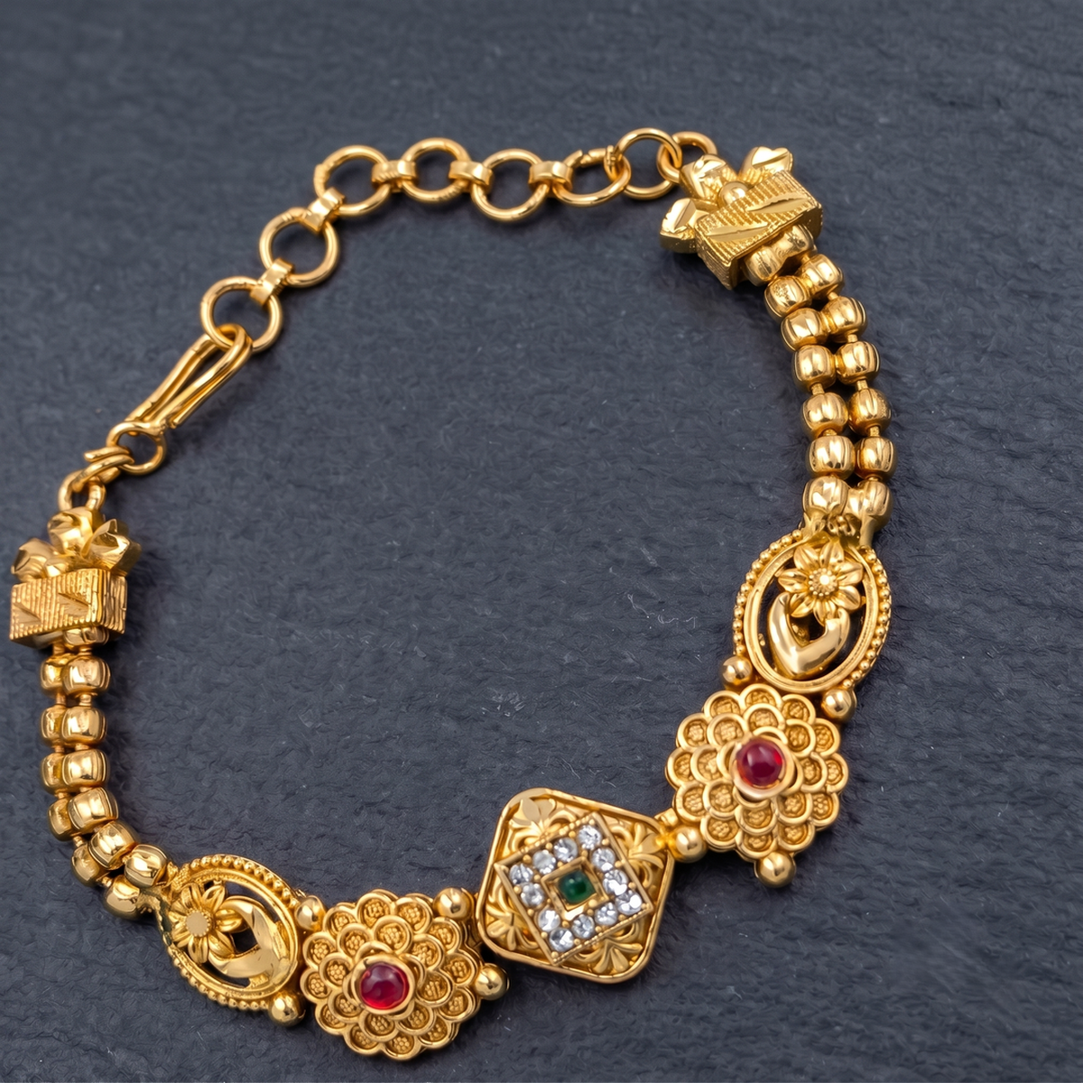 DIVYORO FLORAL MOTIF TRADITIONAL GOLD BRACELET WITH RUBY AND EMERALD ACCENTS