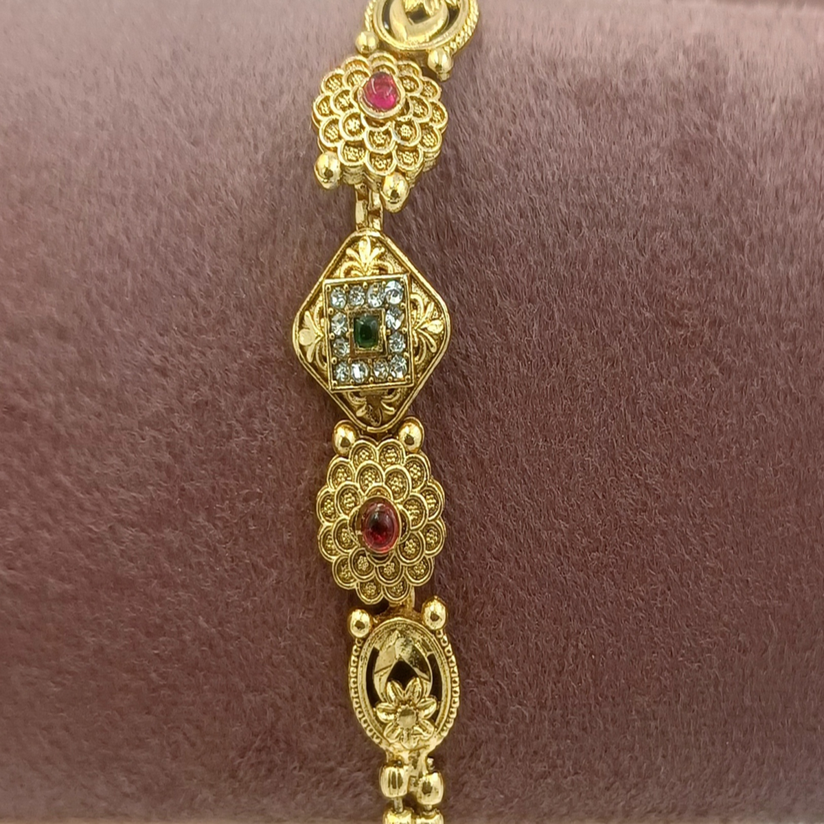 DIVYORO FLORAL MOTIF TRADITIONAL GOLD BRACELET WITH RUBY AND EMERALD ACCENTS