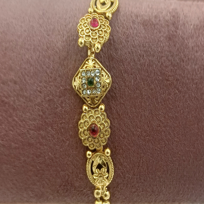 DIVYORO FLORAL MOTIF TRADITIONAL GOLD BRACELET WITH RUBY AND EMERALD ACCENTS
