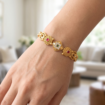 DIVYORO FLORAL MOTIF TRADITIONAL GOLD BRACELET WITH RUBY AND EMERALD ACCENTS
