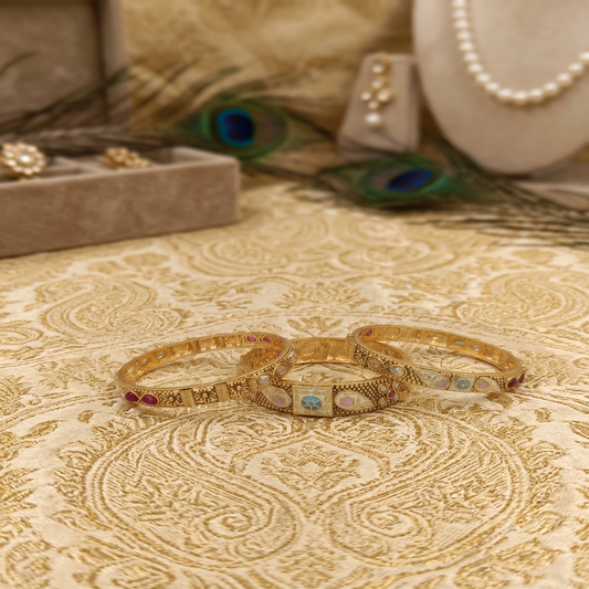 DIVYORO ELABORATE ANTIQUE GOLD BANGLE SET WITH MULTICOLOR ENAMEL AND GEMSTONE ACCENTS