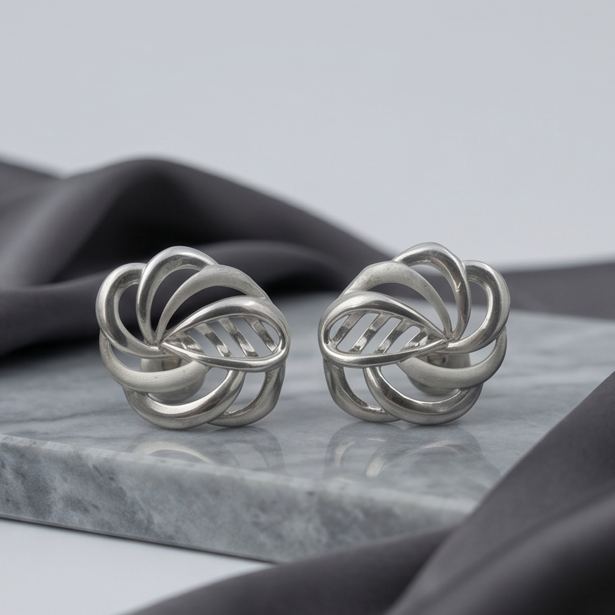 DIVYORO INTERTWINED SILVER STUDS EARRING