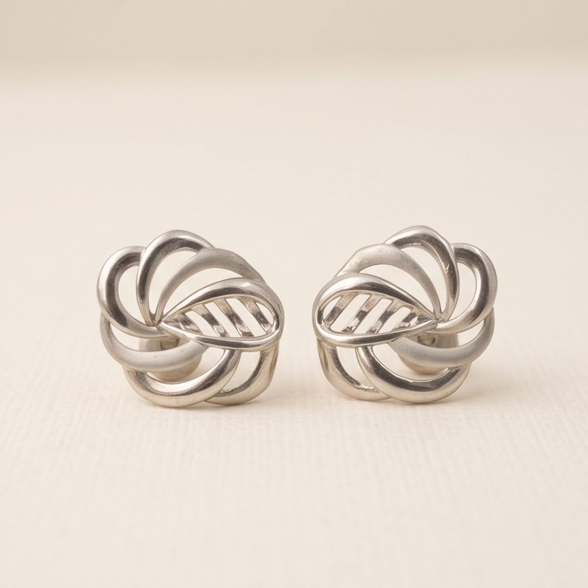 DIVYORO INTERTWINED SILVER STUDS EARRING